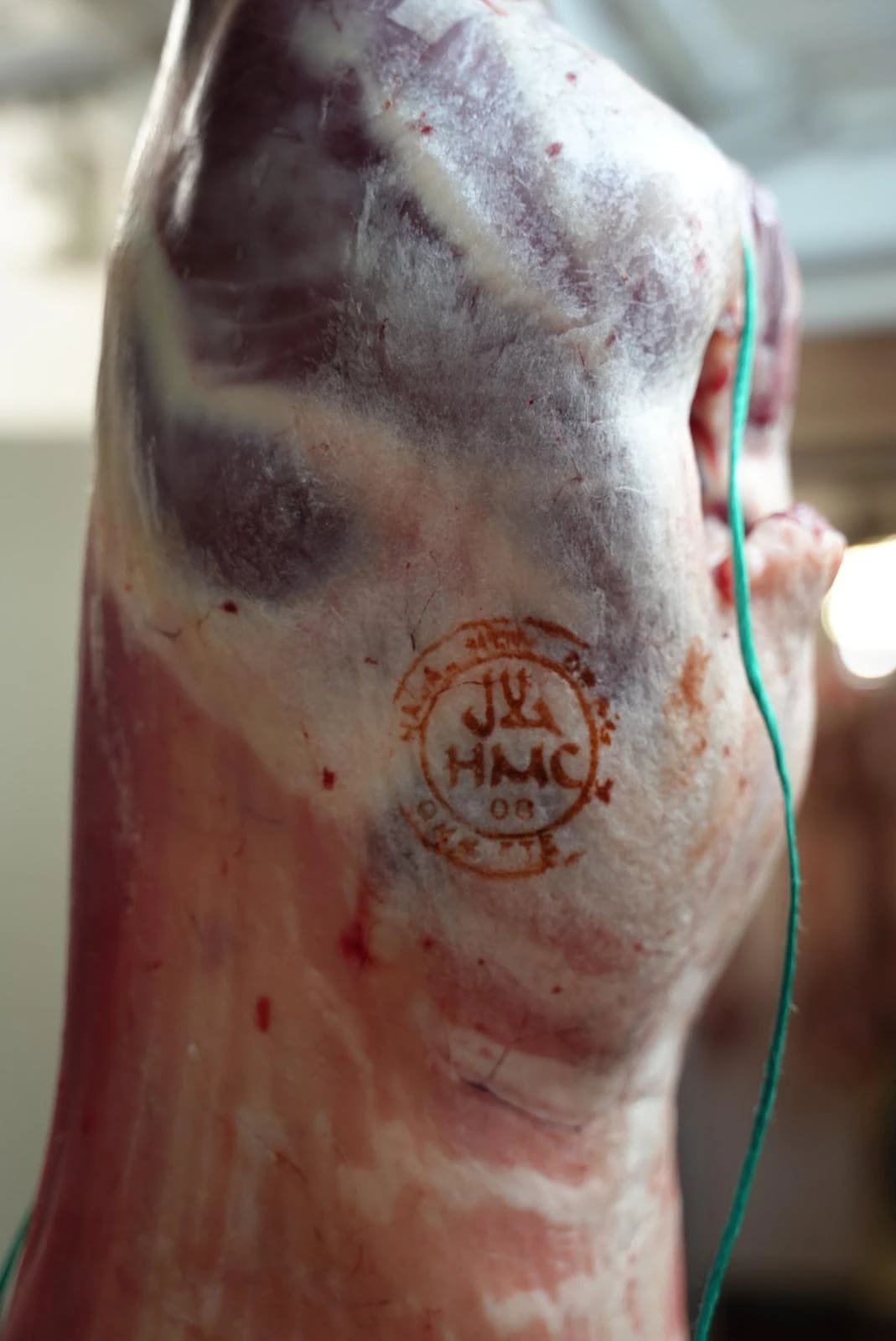 The HMC stamp on a lamb carcass in the chiller
